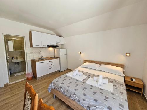 a large bedroom with a bed and a kitchen at Holiday Resort Balota in Viganj