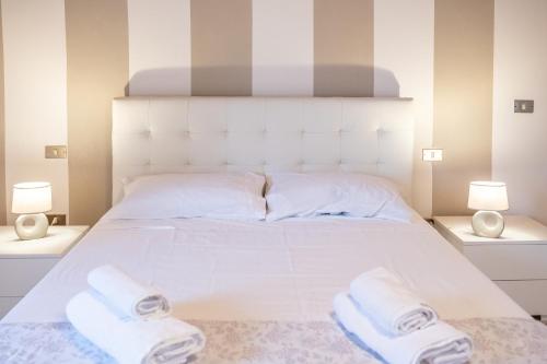 a bedroom with a white bed with towels on it at Casa Vacanze Francesca in Mondolfo