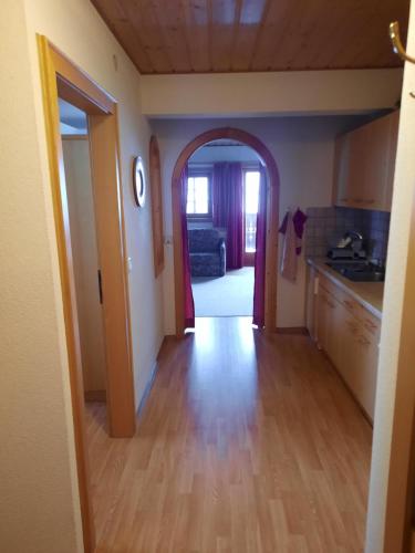 an open hallway leading to a kitchen with an archway at Obenfigerhof in Kals am Großglockner