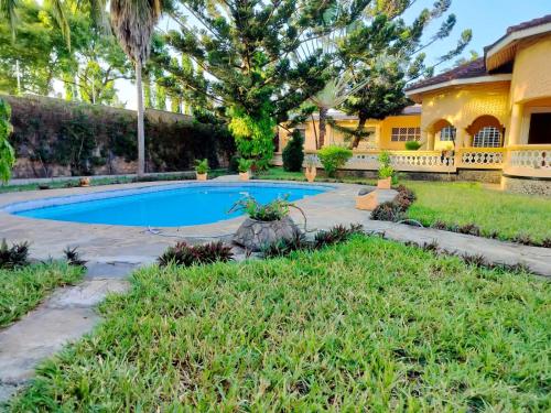 a swimming pool in the yard of a house at Holiday 1 bedroom in Ukunda