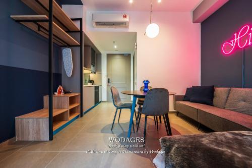 a living room with a table and a couch at Mossaz at Empire Damansara by Wodages in Kuala Selangor