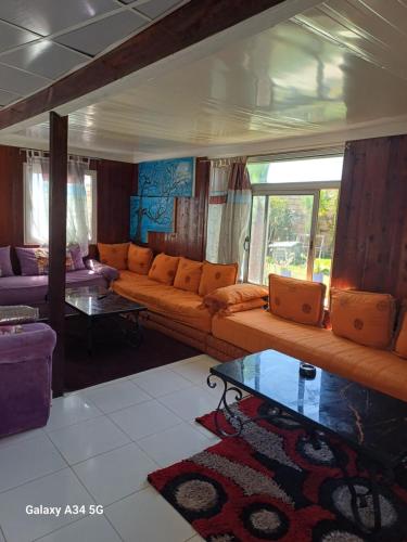 a living room with a couch and a table at Dar redouane in El Jadida