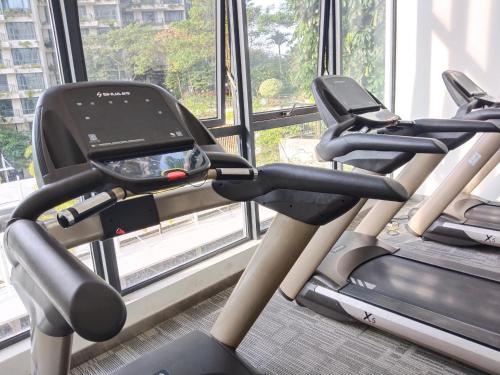a gym with two cardio machines in front of a window at Holiday SweetHome at Forest City 2BR1B with TV Box 4-6pax 1807 in Gelang Patah