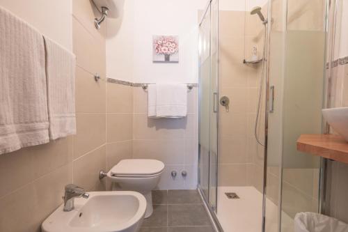 a bathroom with a toilet and a sink and a shower at Hotel Ascot in Rome