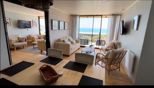 a living room with a view of the ocean at Cabañas Pacífico Matanzas Completa in Matanzas