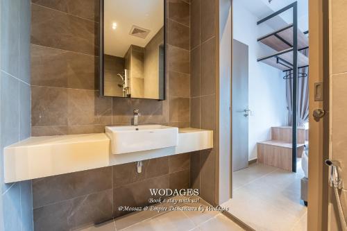 a bathroom with a sink and a mirror at Mossaz at Empire Damansara by Wodages in Kuala Selangor
