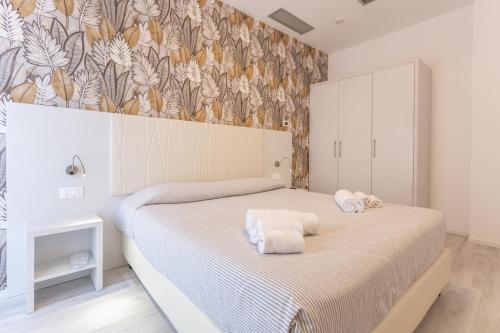 a bedroom with a bed with towels on it at Residence Hotel Angeli in Rimini