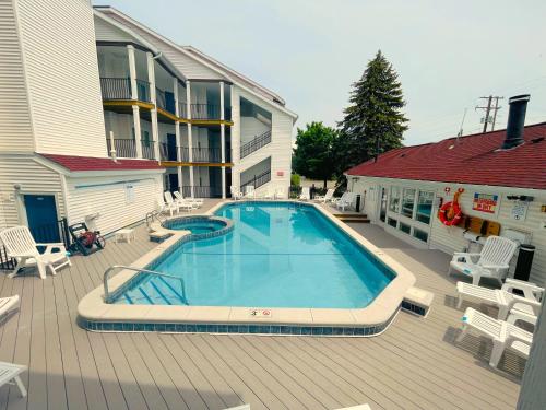 a swimming pool on a deck next to a building at Surreal Views #328 Beach Pool AC Hot Tub in Traverse City