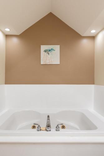 a bathroom with a white sink and a mirror at Surreal Views #328 Beach Pool AC Hot Tub in Traverse City