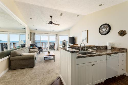 a kitchen and living room with a view of the ocean at Surreal Views #328 Beach Pool AC Hot Tub in Traverse City