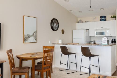 a kitchen with a table and chairs and a counter at Surreal Views #328 Beach Pool AC Hot Tub in Traverse City