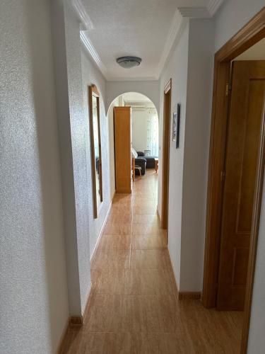a hallway leading to a living room with white walls at La Mirada in Orihuela