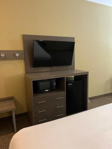 a entertainment center with a flat screen tv on top at Comfort Inn & Suites Monahans I-20 in Monahans