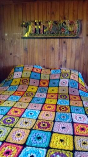 - une couette colorée sur un lit dans l'établissement Le chalet, à Peynier