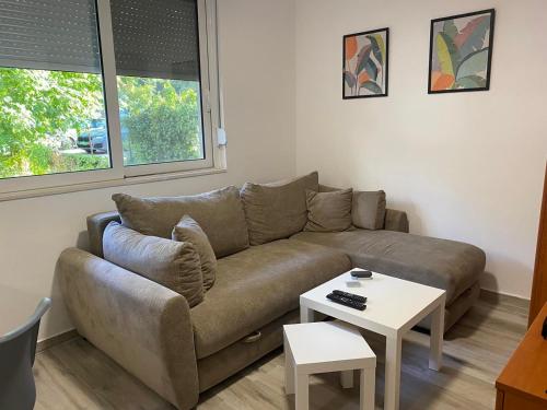 a living room with a couch and a table at Ana one bedroom apartment, 1min from Old Town, Budva in Budva