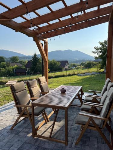a wooden table and chairs on a patio at Casa Dobra in Dobra