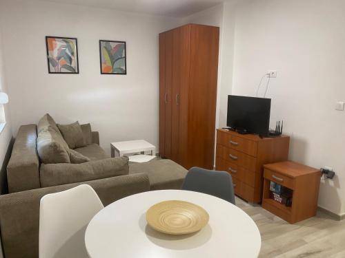 a living room with a couch and a table at Ana one bedroom apartment, 1min from Old Town, Budva in Budva