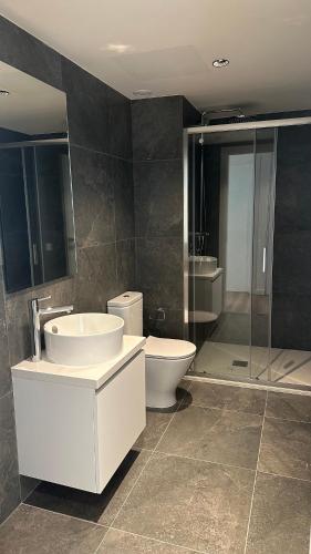 a bathroom with a sink and a toilet and a shower at Sunset Gardens - Holiday Apartments - by TLV Living in Limassol