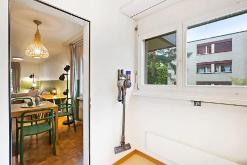 a room with a window and a table with chairs at Beautiful Boutique Apartment DRAHTZUG8 in Zürich