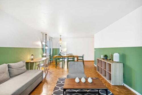 a living room with a couch and a table at Beautiful Boutique Apartment DRAHTZUG8 in Zürich