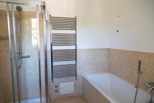 a bathroom with a bath tub and a shower at Hotel Villa Tiziana in Marina di Pietrasanta