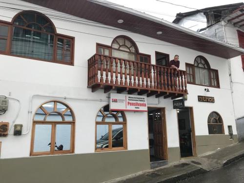 a man standing on a balcony of a building at Athos Hotel Boutique in Bolivia