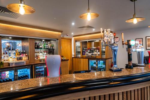 a bar in a pub with a counter with alcohol at Eastwood Hall in Eastwood