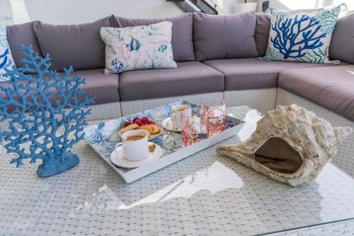 a coffee table with a tray of food on a couch at Casa Mazagón con vistas al mar in Mazagón