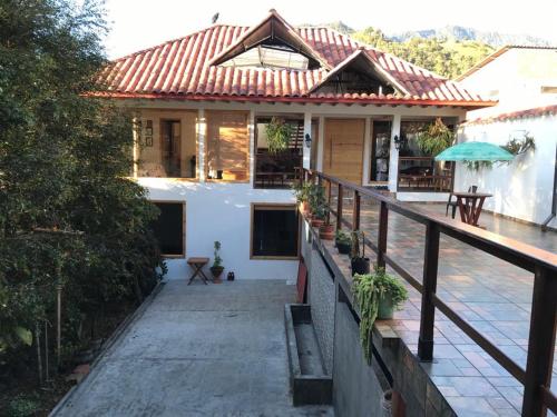 a house with a red roof and a balcony at Athos Hotel Boutique in Bolivia