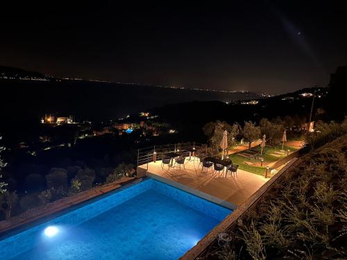 a swimming pool at night with a view at Colago Private Villas Lake Garda in Toscolano Maderno