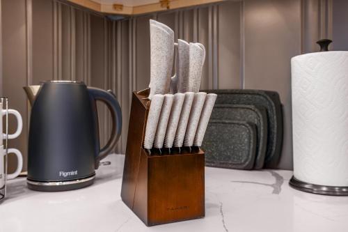 a group of toothbrushes in a wooden holder on a table at 3BR2Bth Parking Cambridge Boston W&D Subway AC in Somerville