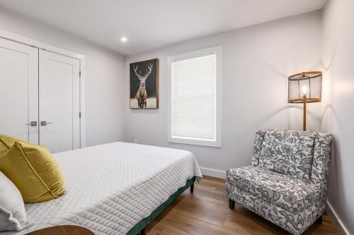 a bedroom with a bed and a chair at 3BR2Bth Parking Cambridge Boston W&D Subway AC in Somerville