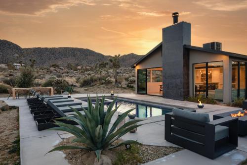 a house with a pool in the desert at Amaru Muru - Luxury Retreat with Pool/Hot Tub/Yoga in Joshua Tree