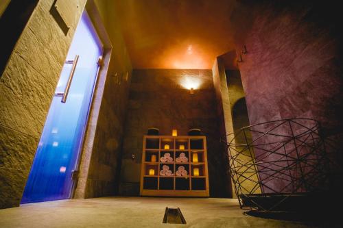 a room with a door and a shelf of wine bottles at La Cresta Chalet in Breuil-Cervinia