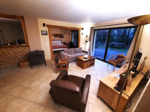 an aerial view of a living room with a couch and chairs at L'appel de la foret in Rocroi