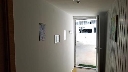 a hallway with a door leading to a courtyard at Studio dAires in Coimbra