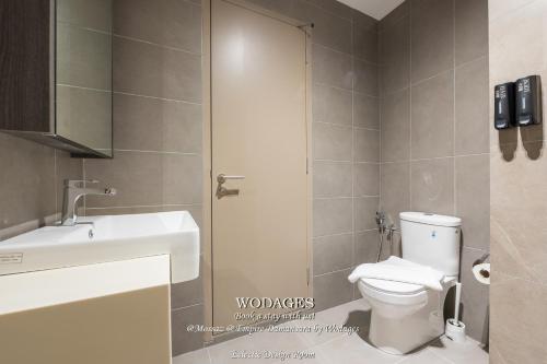 a bathroom with a toilet and a sink at Mossaz at Empire Damansara by Wodages in Kuala Selangor