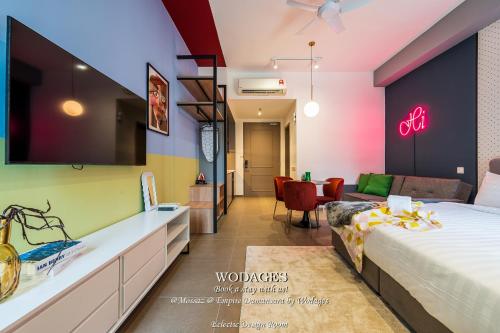 a hotel room with a bed and a living room at Mossaz at Empire Damansara by Wodages in Kuala Selangor