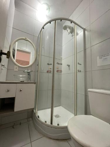 a bathroom with a shower with a sink and a toilet at Break House Beach in Florianópolis