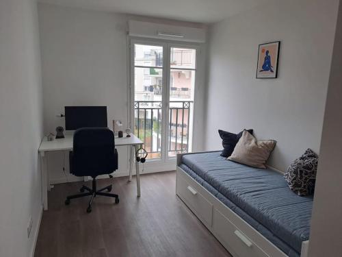 a bedroom with a bed and a desk with a computer at Cosy & Modern Flat Near Paris ! in Le Blanc-Mesnil