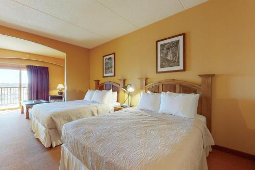a hotel room with two beds and a window at Chula Vista Condo 2444/2446 Full property in Wisconsin Dells
