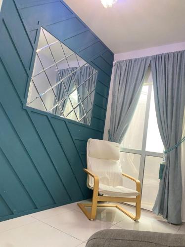 a room with a chair and a window at Izz Homestay 6Pax 3R2B Puncak Alam in Bandar Puncak Alam