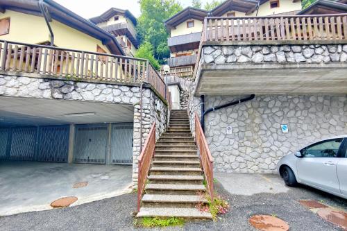 a set of stairs leading to a building with a car at Mountain View - Il Sole tutto l'Anno in Lizzola Alta