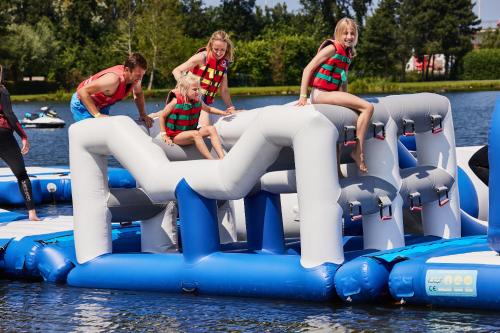 a group of young girls riding on an inflatable raft at Holiday Suites Jabbeke - Klein Strand in Jabbeke