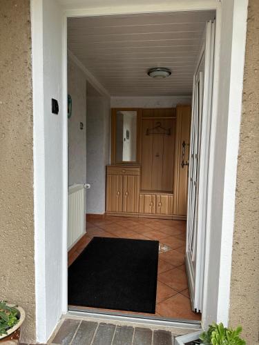 a hallway with a black rug on the floor at Ferienhaus in Grevesmühlen