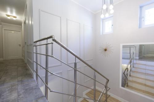 a hallway with white walls and a metal staircase at Complex turistic Veverita in Ranca