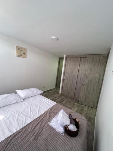 a bedroom with a bed with a basket on the floor at Horeb Paradise in La Tebaida