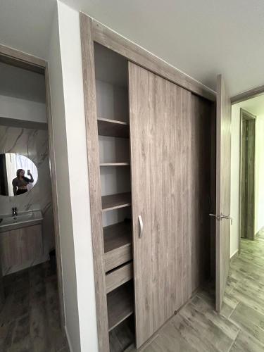 a room with a wooden closet with a mirror at Horeb Paradise in La Tebaida