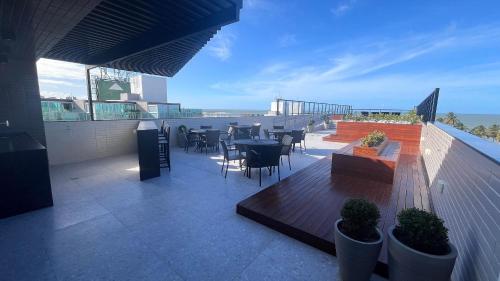 a balcony with a table and chairs on a building at Flat Premium Legacy Suites - Cabo Branco in João Pessoa