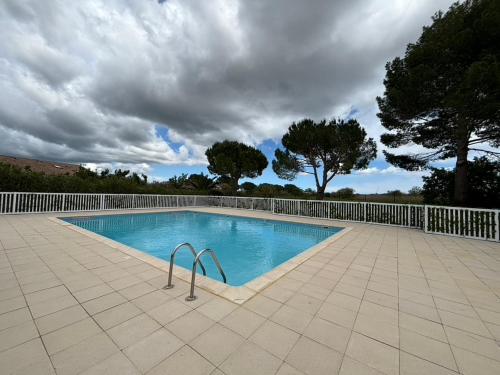une piscine entourée d'une clôture blanche. dans l'établissement La maison du bonheur, à Mèze